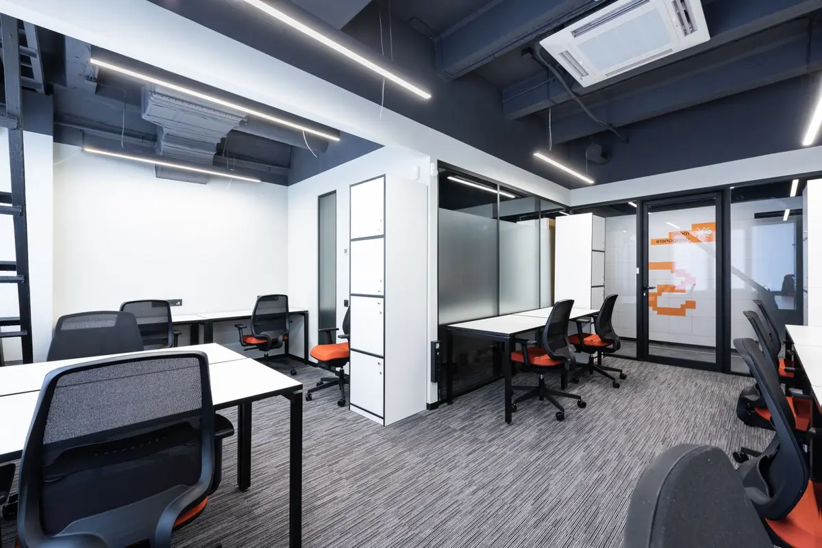 Clean open-plan office workspace with rows of desks