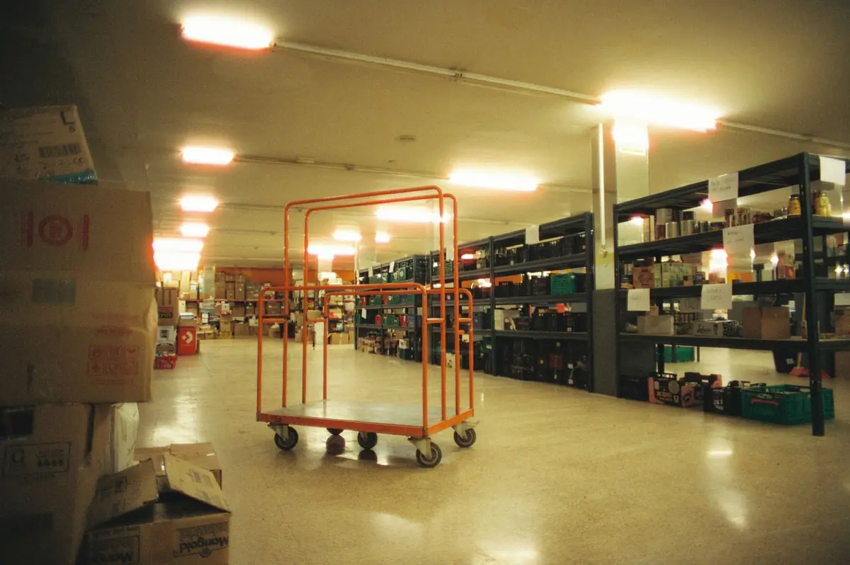 Warehouse aisle with shelving and a clear concrete floor